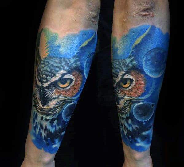 Blue Ink Background With Planets And Owl Head Mens Forearm Tattoo