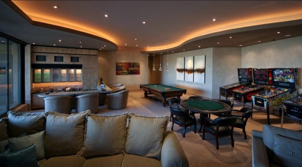 basement game room with billiards, arcade games, and lounge area